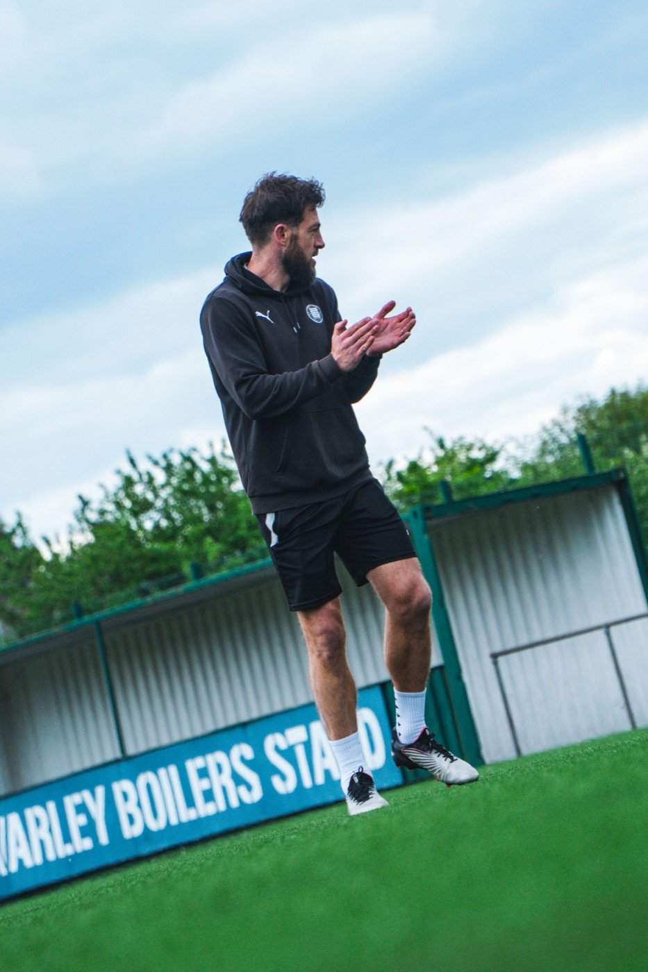 Head coach Craig Bentham applauding on the pitch