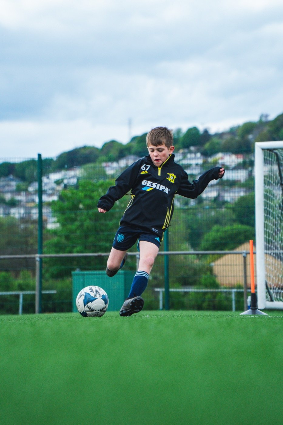 Player striking the ball at a Midfield Maestro session
